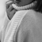 Timeless Fashion - Black and White Picture of a Young Woman in a Sweater