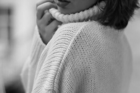 Timeless Fashion - Black and White Picture of a Young Woman in a Sweater