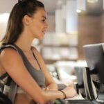 Body-inclusive Shopping. - Fit smiling sportswoman waiting at gym reception desk