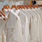 Capsule Wardrobe - Clothes in Neutral Colors Hanging on the Racks in a Clothing Store