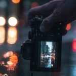 Day-to-night Transition - Person Holding Black Dslr Camera Taking Photo of City Lights during Night Time