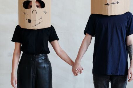 Creative Diy Fashion - A Couple Wearing Diy Cardboard Box Mask While Holding Each Other's Hands